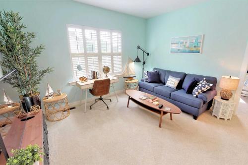 a living room with a blue couch and a table at 2 Mi to Bethany Beach Family-Friendly Home! in Ocean View