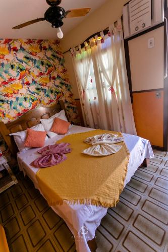 a bedroom with a bed with towels on it at Pousada Dunas Braga in Cabo Frio