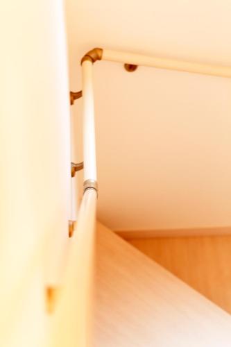 a close up of a white door with a pipe at Guest House Ochakare in Kanazawa