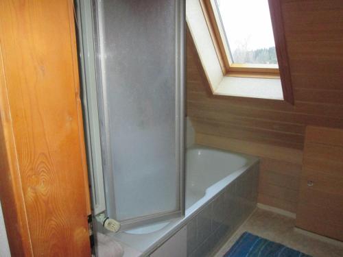 a shower in a bathroom with a window and a bath tub at FeWo Ahornweg in Selb