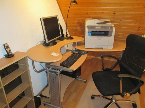 an office with a desk with a computer and a printer at FeWo Ahornweg in Selb