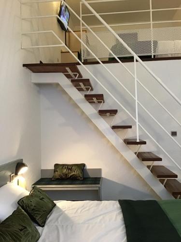 a bedroom with a bed and a staircase at Hôtel Christ Roi in Lourdes