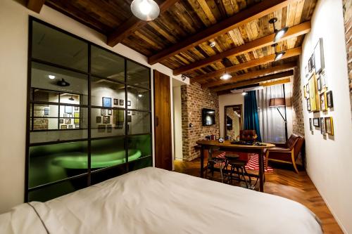 ein Schlafzimmer mit einem großen Bett und einem Tisch in der Unterkunft Hotel The Designers Jongro in Seoul