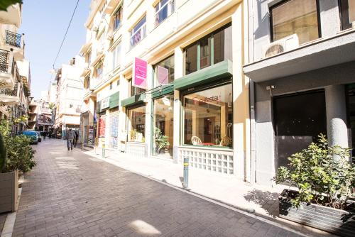 a street with a bunch of shops and buildings at Safestay Athens Monastiraki in Athens