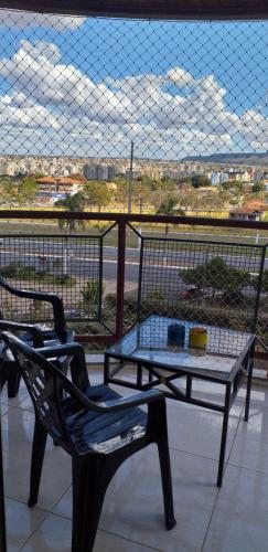 a table and a bench on a balcony with a view at Apartamento Mundi - Império Romano - Caldas Novas in Caldas Novas