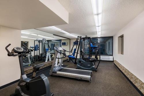 a gym with treadmills and machines in a room at Travelodge by Wyndham Memphis Airport/Graceland in Memphis