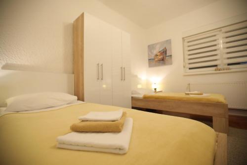 a bedroom with two beds with towels on them at InOsijek- FEELS LIKE HOME in Osijek