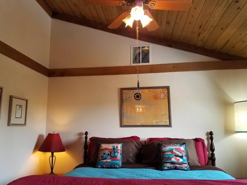 Un dormitorio con una cama y un ventilador de techo. en Starry Nights Ranch Bed & Breakfast, en Mancos