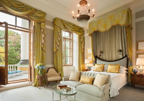 
a living room filled with furniture and a window at Four Seasons Hotel Lion Palace St. Petersburg in Saint Petersburg
