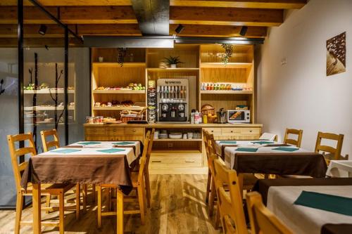 a restaurant with tables and chairs in a room at Posada rural Fuente Juliana in Barrio de Arriba
