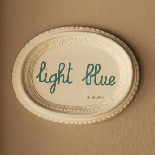 a white plate with the words light blue on it at LO SGUARDO in Sulzano