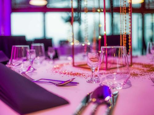 a table with wine glasses on a pink table cloth at Mercure Cieszyn in Cieszyn
