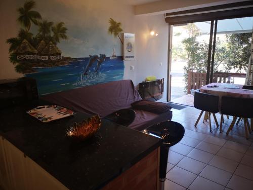 a living room with a couch and a table at MAS de La Mer in Saint Cyprien Plage