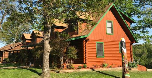 an orange house with a tree in front of it at Crown Lake Resort in Horseshoe Bend