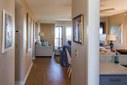 a hallway leading to a living room and a living room at Pelican Point Unobstructed Beach Views Beach Access out back door! in Harbor Island