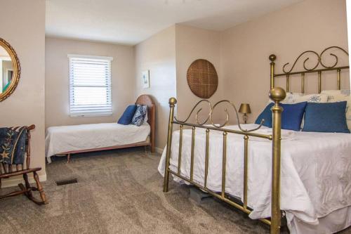 a bedroom with a bed and a chair and a mirror at Pelican Point Unobstructed Beach Views Beach Access out back door! in Harbor Island