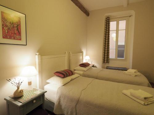 a bedroom with two beds and a window at 2 Bedroom Apartment Old Town Centre in Nice