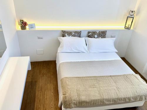 a small bedroom with a bed in a small room at Soggiorno Lo Stellino in Siena