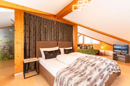 a bedroom with a large bed in a room at Villa Heimatliebe in Ramsau im Zillertal