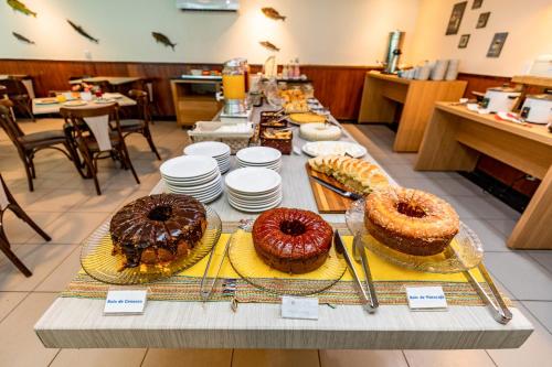 a table with different types of cakes on display at Hotel Ponta Negra Beach Natal in Natal