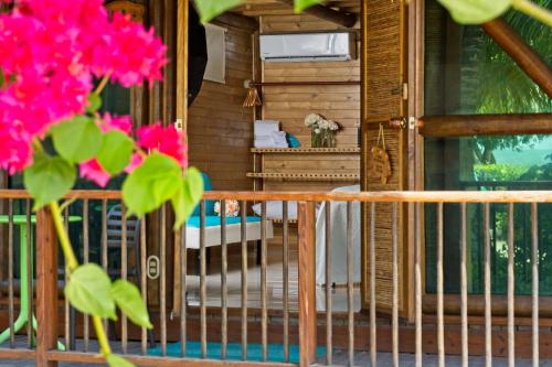a balcony of a house with pink flowers at Hotel Isla del Encanto in Baru