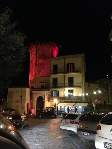 a building with a red lighted tower on top of it at Casa Vacanze Torre di Mola in Formia
