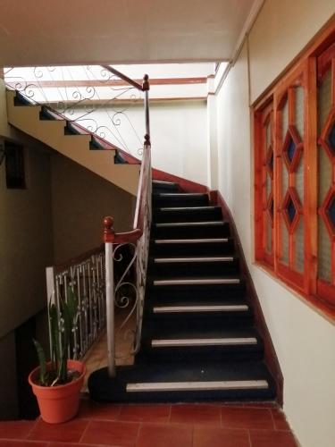 a staircase in a building with a stair case at Hotel Escorial in La Serena