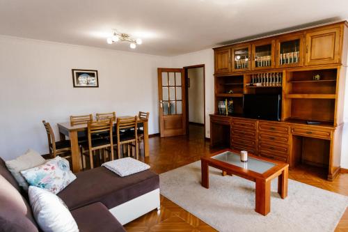a living room with a couch and a table at Castle Apartment in Guimarães