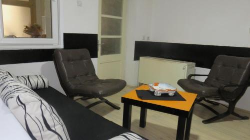 a room with two chairs and a table and a couch at Guest House Pavlovic in Soko Banja