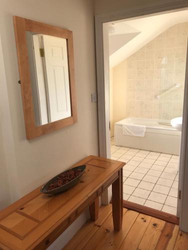 a bathroom with a table and a bath tub at 1 Sheen View in Kenmare