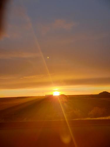 a view of the sun setting over a highway at The Blackhouse Cottage in Hokitika