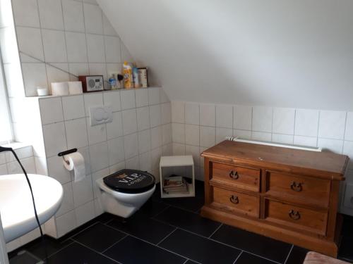 a small bathroom with a toilet and a sink at Forsthof in Bergen