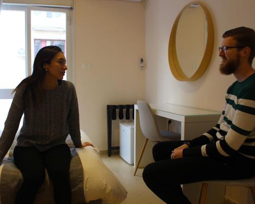 a man and a woman sitting on a bed at B12 Inn in Jerusalem