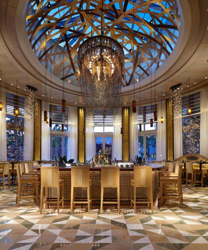 a dining room with a chandelier and tables and chairs at Seminole Hard Rock Hotel & Casino Hollywood in Fort Lauderdale