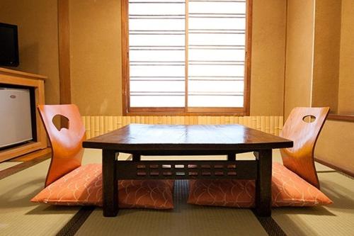 a living room with a table and two chairs at Hotel Edoya in Tokyo