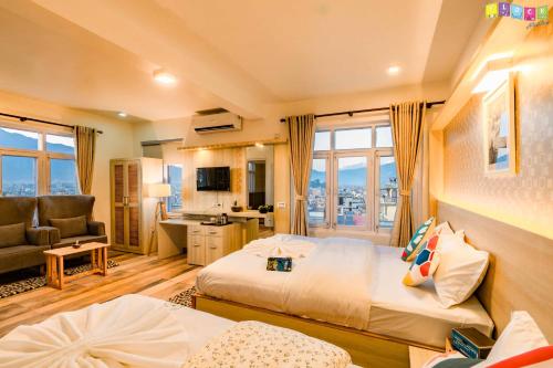 a hotel room with two beds and a living room at Flock Kathmandu in Kathmandu