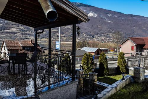 a house with a balcony with a view of a mountain at Ema Guest House in Plav