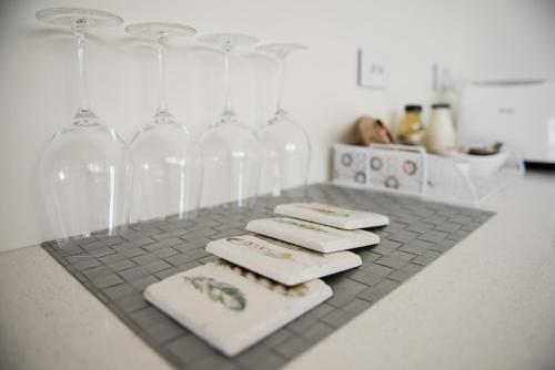 a group of wine glasses and napkins on a counter at The Lodges At Transport World in Invercargill