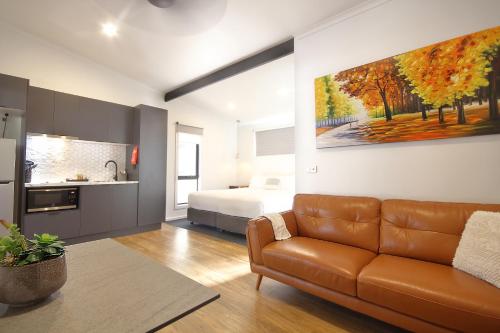 a living room with a couch and a bed at BIG4 Yarra Valley Park Lane Holiday Park in Healesville