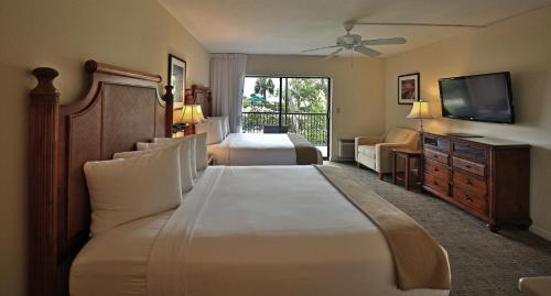 a hotel room with two beds and a television at Sanibel Inn in Sanibel