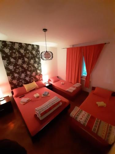 a living room with two beds and a window at Apartmani LolaNola in Vrnjačka Banja