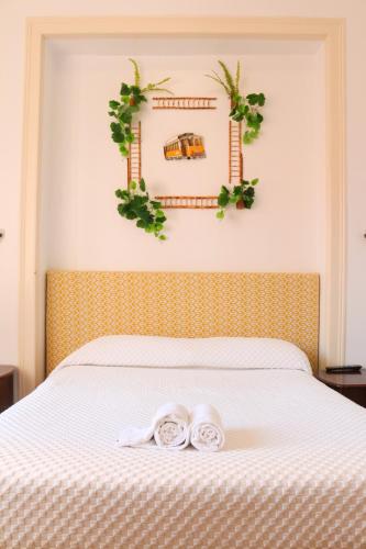 a bedroom with a bed with two towels on it at Casa Londres in Estoril