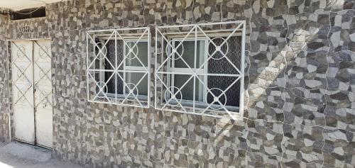 two windows on the side of a stone wall at Departamentos muy cercanos al aeropuerto T2 wifi free in Mexico City