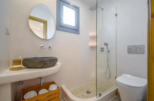 a bathroom with a sink and a glass shower at Asterias Studios in Agia Anna Naxos