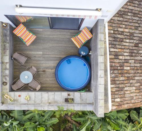 an overhead view of a backyard with a pool and chairs at Marketplace Apartment 1 in Ponta Delgada