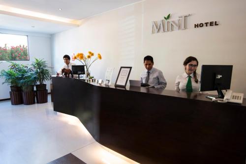 a man and a woman sitting at a table in front of a laptop at Mint Hotel in Arequipa