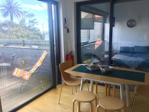 a dining room with a table and chairs and a balcony at Marketplace Apartment 1 in Ponta Delgada