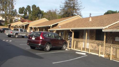 a car parked in a parking lot next to a building at Laurel Inn in Oakland