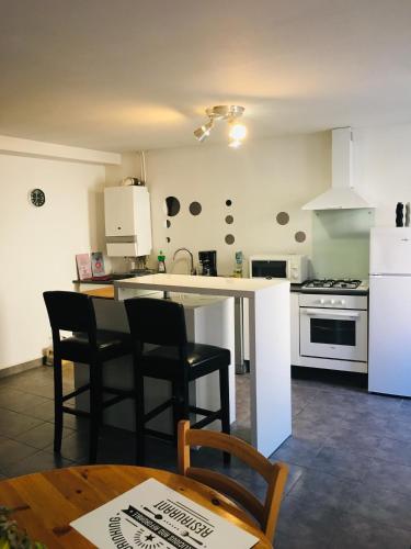 a kitchen with a table and chairs and a counter top at Gîte de vac’s et d’affaires à Monthermé in Monthermé