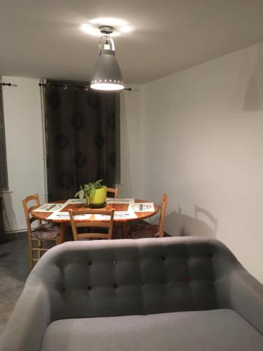 a living room with a table and a couch at Gîte de vac’s et d’affaires à Monthermé in Monthermé